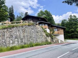 a house on a rock next to a road at Chalets Abbe/tot - Chalet de Tôt MAE-4004 in Crest-Voland