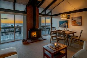 a living room with a fireplace and a table at Family Tides in Ventura