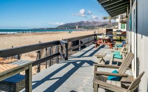 a deck with chairs and tables on the beach at Family Tides in Ventura
