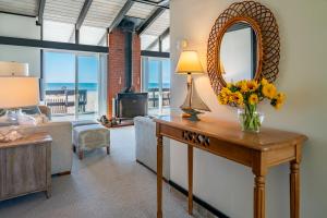 a living room with a table with a mirror at Family Tides in Ventura