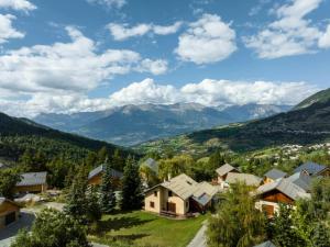 an aerial view of a small village with mountains in the background at Résidence Pramouton - Un logement tout confort au cœur d’un chalet MAE-0411 in Le Mélézet
