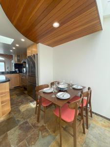 a dining room with a table and chairs and a kitchen at Dragan's Cove in Oxnard