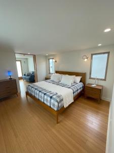 a large bedroom with a bed and a window at Dragan's Cove in Oxnard