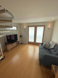 a living room with a couch and a flat screen tv at Dragan's Cove in Oxnard