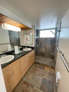 a bathroom with a shower and a sink and a mirror at Dragan's Cove in Oxnard +21 photos