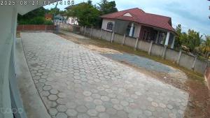 a stone driveway in front of a house at Dia Roomstay Gong Badak in Kampong Gong Badak