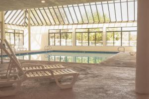 a swimming pool with a bench in a building at Surfside Four in Port Hueneme