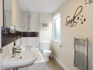 a white bathroom with a sink and a toilet at The Loft, Lynmouth - Uk41697 in Lynmouth
