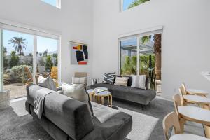 a living room with two couches and a table at House of Light by ACME House Company in Palm Springs