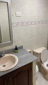 a bathroom with a sink and a toilet and a mirror at Habitación independiente cerca al aeropuerto # 5 in Cartagena de Indias