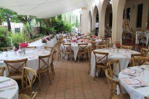 a banquet hall with tables and chairs with flowers on them at The Riverine Club in Wagga Wagga