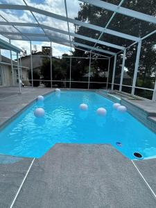 a swimming pool with blue water in a building at 5 Bedroom 4 Bathroom Pool Gym Leesburg Retreat in Leesburg