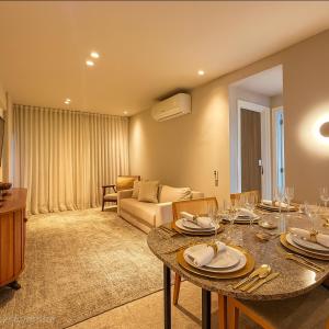 a living room with a table and a couch at 535 Flat Residência in Salvador
