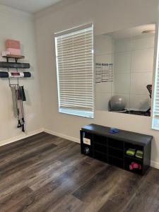 a living room with a table and a mirror at 5 Bedroom 4 Bathroom Pool Gym Leesburg Retreat in Leesburg