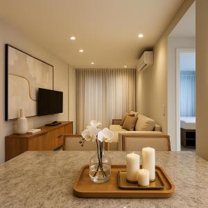 a kitchen and living room with a table with candles at 535 Flat Residência in Salvador
