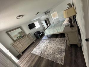 a bedroom with a bed and a dresser and a desk at 5 Bedrooms, 4 Bathrooms, Pool, Gym, Sleeps 16 Leesburg Retreat!!!! in Leesburg