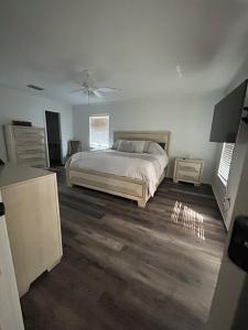 a bedroom with a bed and a ceiling fan at 5 Bedroom 4 Bathroom Pool Gym Leesburg Retreat in Leesburg +17 photos