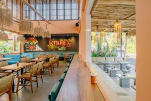 a dining room with tables and chairs in a restaurant at Sokkool Coliving and Coworking - Near Berawa Beach in Canggu