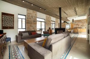 a living room with two couches and a table at Villa Pnai in Rosh Pinna