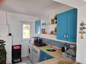 a kitchen with blue cabinets and a sink at villa Loya in Ortaca