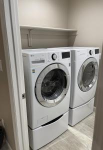 two washing machines sitting next to each other in a room at Sequoia Oasis near Downtown Exeter in Exeter