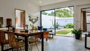 an open living room with a dining table and chairs at Mamaya Rental Villas El Nido in El Nido Airport