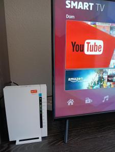 a video game system next to a tv at Vikend kuća Konjic in Konjic