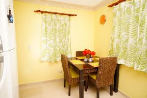 a dining room with a table and two chairs at Garden condos, unit#8 in Sosúa