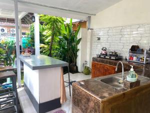 a kitchen with a sink and a counter top at Neo Robiu & Ijen Tour in Banyuwangi