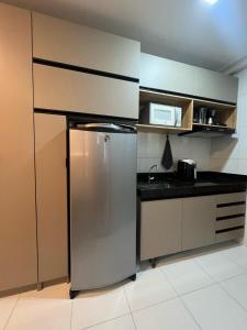 FLAT DE LUXO vista piscinas, Praia de Muro Alto - Malia Beach في إيبوجوكا: مطبخ مع ثلاجة ستانلس ستيل في الغرفة +109 صور