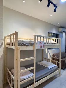 two bunk beds are in a room with a wall at Metrocity Square Condominium 3R2B - 8 Pax in Kuching