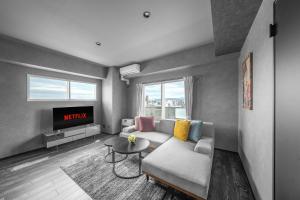 a living room with a couch and a table at J-star 901 in Sapporo