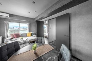 a living room with a couch and a table at J-star 901 in Sapporo