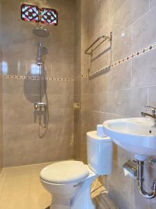 a bathroom with a toilet and a sink at The Jero Ubud in Ubud