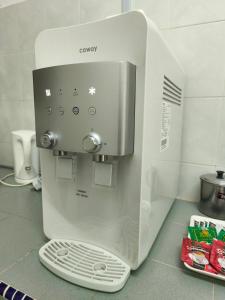 a white coffee maker sitting on top of a counter at 22 Homestay Tenom in Tenom
