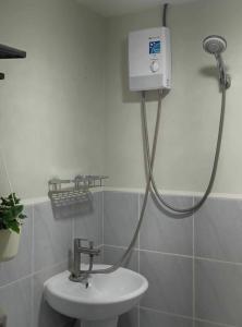 a shower in a bathroom with a sink at Studio w pool & balcony, city & mountain view Mactan airport in Suba +12 photos