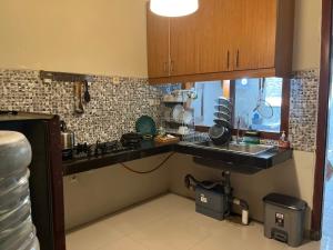 a kitchen with a sink and a counter top at Mawartiga Homestay in Demangan