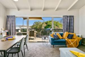 a living room with a blue couch and a table at Mercy of Lake Taupo in Taupo