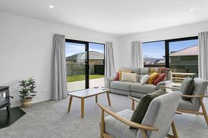 ein Wohnzimmer mit Sofa und Tisch in der Unterkunft Sophistication Meets Relaxation in Taupo
