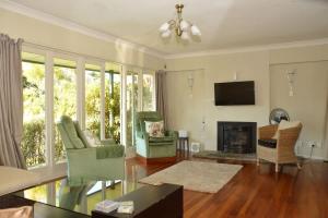 a living room with a fireplace and a tv at Happiness is Huia a block from the lake in Taupo