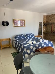 a bedroom with a bed and a table in it at Pousada Barlavento - Ilha Grande - Porto dos Tatus - Delta do Parnaíba - Piscina e Conforto in Ilha Grande de Santa Isabel +26 photos