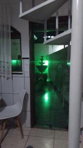 a room with a glass door and a white chair at casa da meg in Tiradentes +14 photos