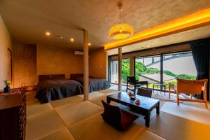 a bedroom with a bed and a table at Okamotoya in Beppu