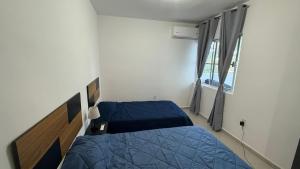 Un dormitorio con dos camas y una ventana. en Aluna Beach - Playa Miramar, en Ciudad Madero