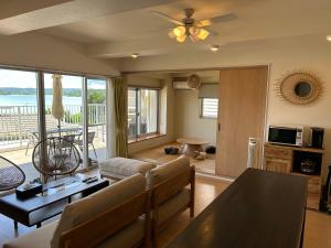a living room with a couch and a table at Four Season Resort Kouri Island in Nakijin