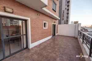 a balcony of a building with a large glass door at Depto en Boulevard con cochera y terraza exclusiva in Santa Fe