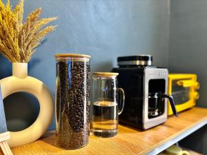 a shelf with two vases filled with coffee beans at Balai Evelyn Homestay in Coron