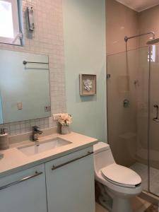 a bathroom with a toilet and a sink and a shower at Casa Frida - Beachfront Ocean View in Puerto Morelos