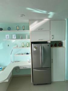 a kitchen with a refrigerator and a sink at Casa Frida - Beachfront Ocean View in Puerto Morelos