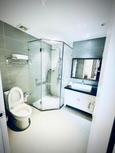 a bathroom with a shower and a toilet and a sink at Camly Chic Villa in Da Lat +31 photos